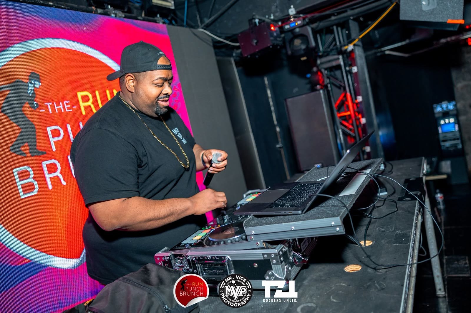 Prince Charm on the decks in front of a glowing LED wall